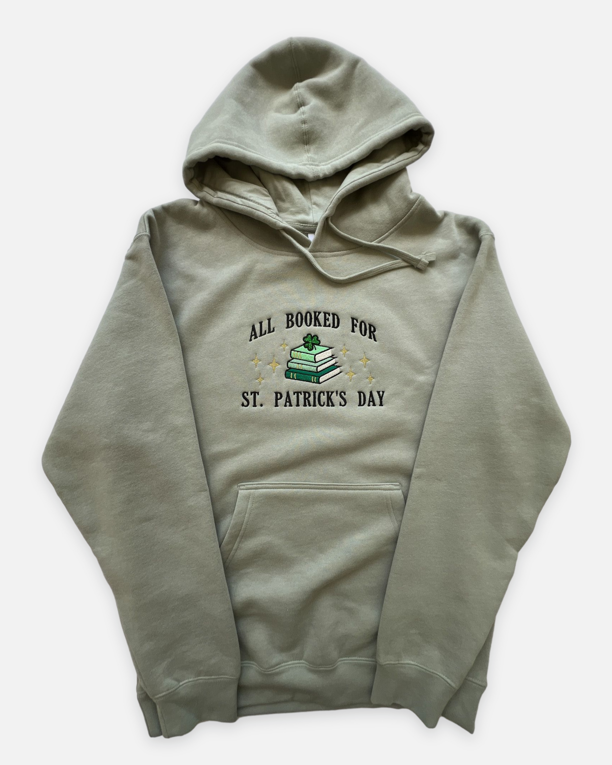 Green hoodie with All Booked for St. Patrick's Day text and stacked books graphic with a glitter green clover on top